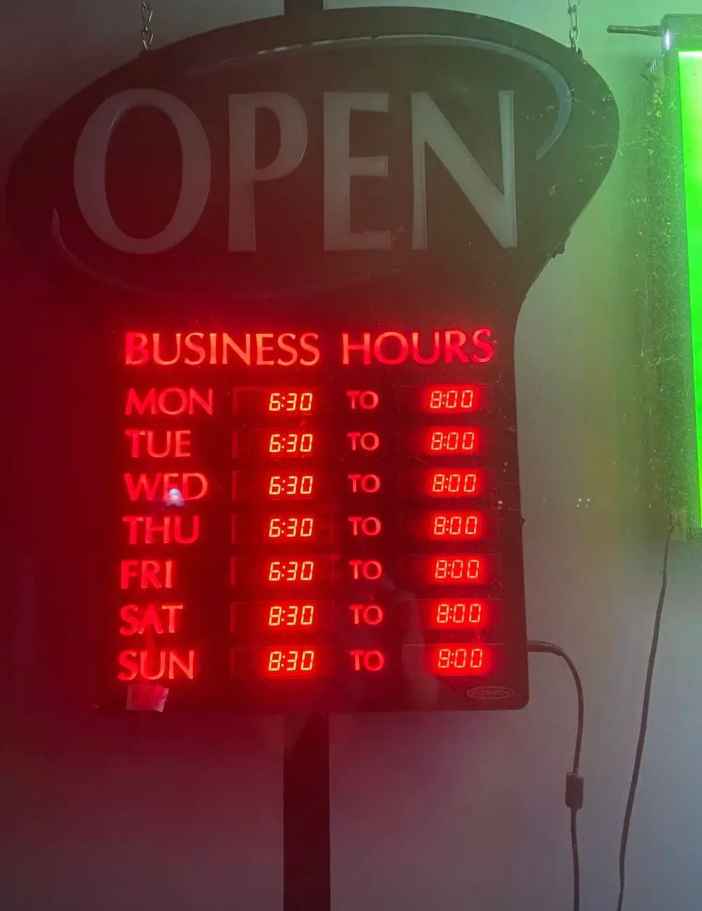 Illuminated Cheney Mini Mart store-hours sign